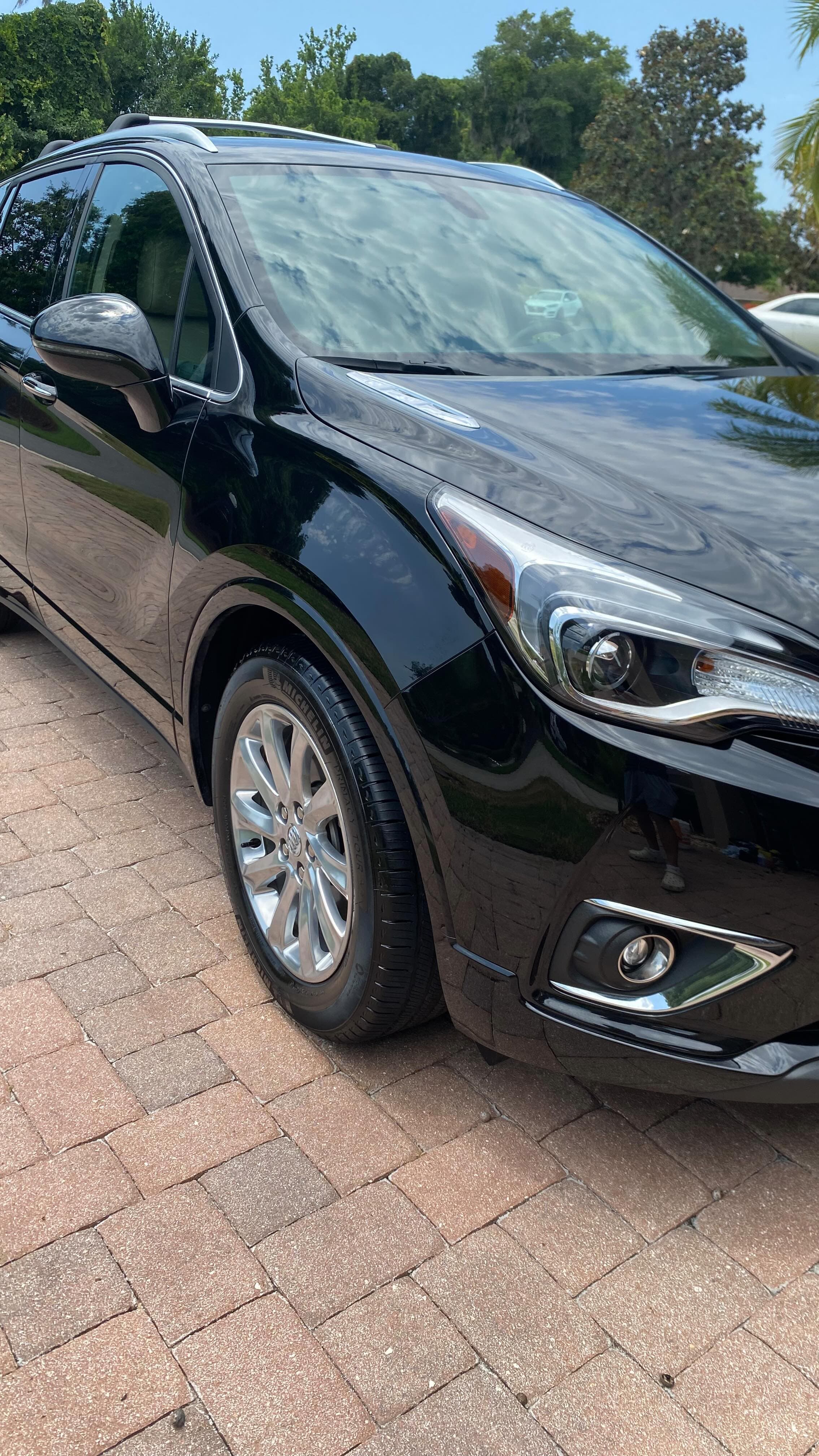 Black Buick Envision with mirror-like exterior finish