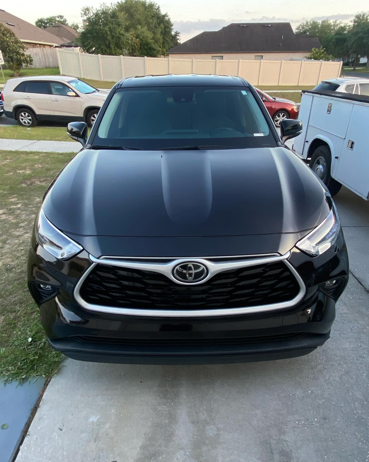 Black Toyota Highlander with clean reflective paint